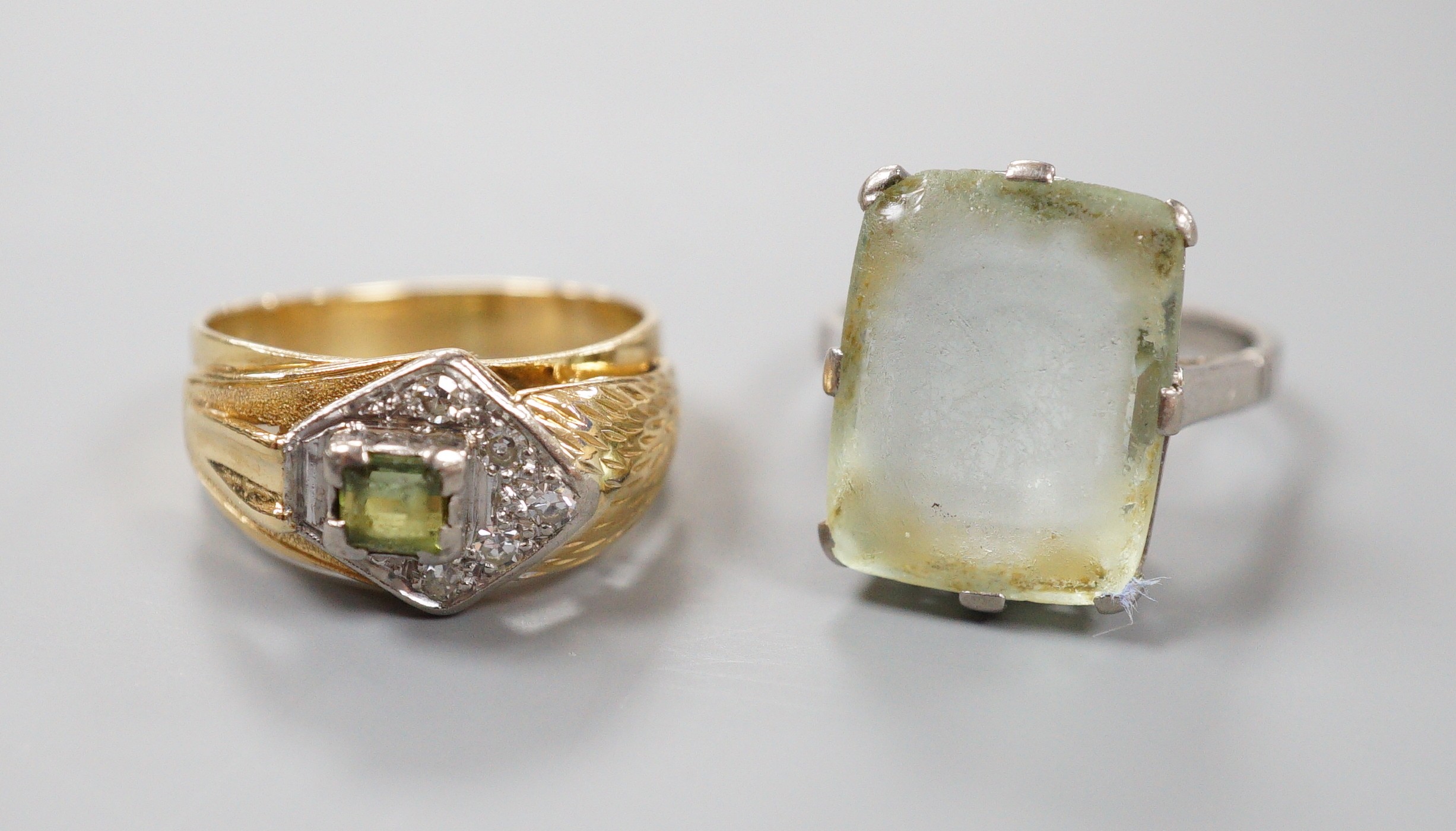 An 18ct white metal and paste set ring, gross 6.1 grams, and one other continental diamond and tourmaline? set cluster ring, stamped 8ct, gross 5.9 grams.